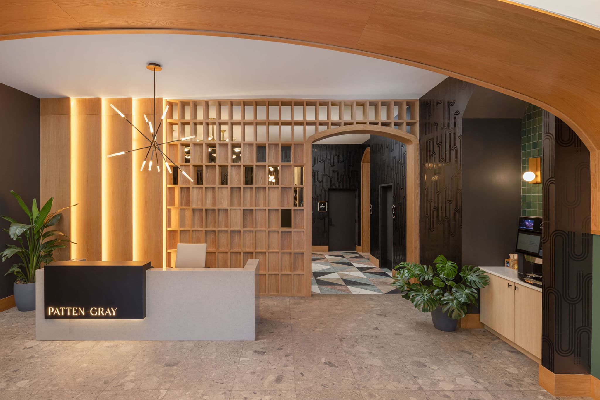 The Patten Gray lobby by Studio 10: an arched oak ceiling, wood lattice and a brass chandelier
